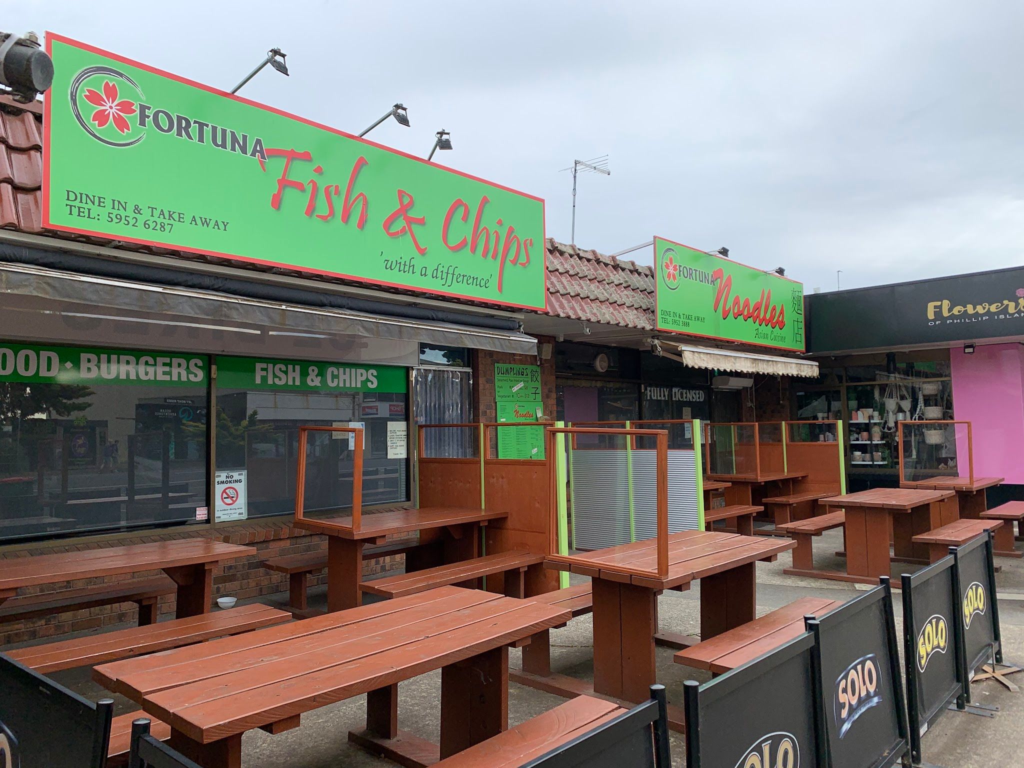 Fortuna Fish and Chips storefront with green signage and outdoor picnic tables, Cowes Phillip Island
